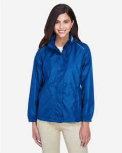 CORE365 78185 Women’s Climate Seam-Sealed Lightweight Variegated Ripstop Jacket – True Royal (on model)