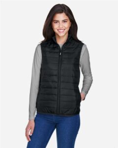 CORE365 CE702W Women’s Prevail Packable Puffer Vest – Black (on model)