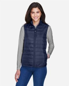 CORE365 CE702W Women’s Prevail Packable Puffer Vest – Classic Navy (on model)