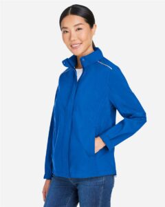 CORE365 CE712W Women’s Barrier Packable Rain Jacket – True Royal (on model side)