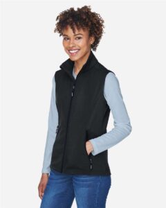 CORE365 CE701W Women’s Cruise Two-Layer Fleece Bonded Soft Shell Vest – Black (on model side)