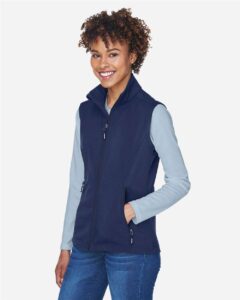 CORE365 CE701W Women’s Cruise Two-Layer Fleece Bonded Soft Shell Vest – Classic Navy (on model side)