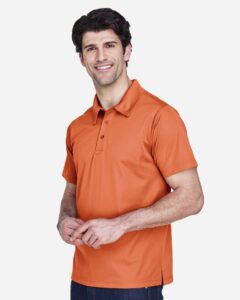 Team 365 TT21 Men’s Command Snag Protection Polo – Sport Burnt Orange (on model side)