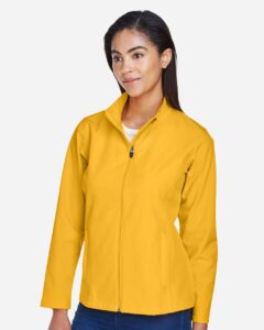 Team 365 TT80W Women’s Leader Soft Shell Jacket – Sport Athletic Gold (on model side)
