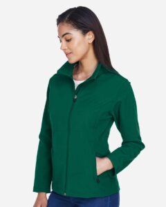 Team 365 TT80W Women’s Leader Soft Shell Jacket – Sport Forest (on model side)
