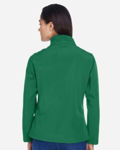 Team 365 TT80W Women’s Leader Soft Shell Jacket – Sport Kelly (on model back)