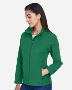Team 365 TT80W Women’s Leader Soft Shell Jacket – Sport Kelly (on model side)