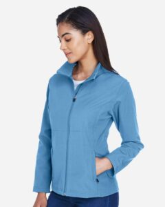 Team 365 TT80W Women’s Leader Soft Shell Jacket – Sport Light Blue (on model side)