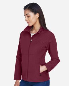 Team 365 TT80W Women’s Leader Soft Shell Jacket – Sport Maroon (on model side)