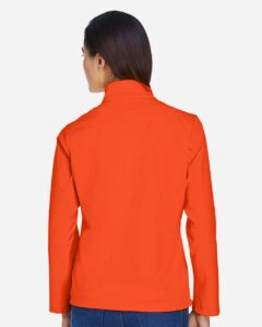 Team 365 TT80W Women’s Leader Soft Shell Jacket – Sport Orange (on model back)