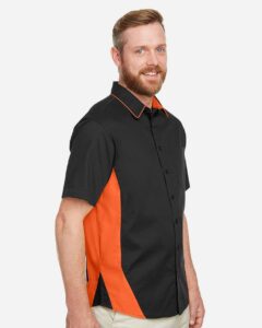 Harriton M586 Men’s Flash IL Colorblock Shirt – Black/ Team Orange (on model side)