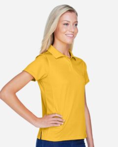 Harriton M315W Women’s Polyester Jersey Polo – Gold (on model side)