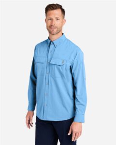 HUK H150184 Men’s Creekbed Pocket Fishing Shirt – Marolina Blue (on model side)