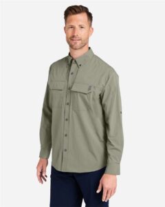 HUK H150184 Men’s Creekbed Pocket Fishing Shirt – Moss (on model side)
