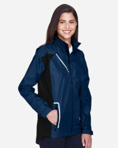 Team 365 TT86W Women’s Dominator Waterproof Jacket – Sport Dark Navy (on model side)