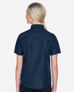 Harriton M580W Women’s Key West Short Sleeve Performance Staff Shirt – Navy (on model back)