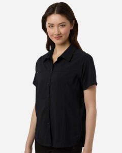 CORE365 CE520W Women’s UltraUVP Shoreline Short Sleeve Staff Shirt – Black (on model side)