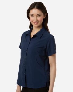CORE365 CE520W Women’s UltraUVP Shoreline Short Sleeve Staff Shirt – Classic Navy (on model side)