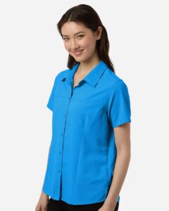 CORE365 CE520W Women’s UltraUVP Shoreline Short Sleeve Staff Shirt – Electric Blue (on model side)