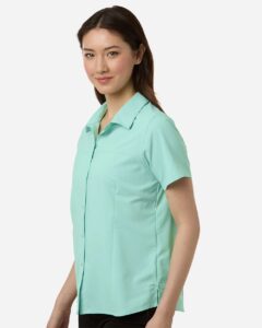 CORE365 CE520W Women’s UltraUVP Shoreline Short Sleeve Staff Shirt – Sea Glass (on model side)
