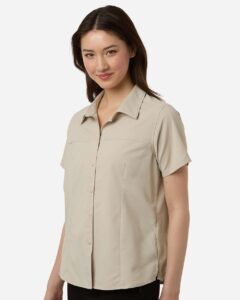CORE365 CE520W Women’s UltraUVP Shoreline Short Sleeve Staff Shirt – Stone (on model side)