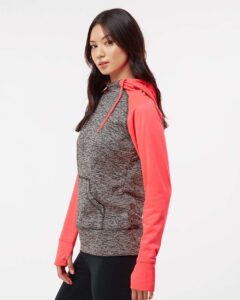 J. America 8618 Women’s Colorblocked Cosmic Fleece Hooded Sweatshirt – Charcoal Fleck/ Fire Coral (on model side)