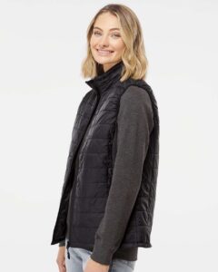 Independent Trading Co. EXP220PFV Women’s Puffer Vest – Black (on model side)