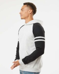JERZEES 97CR Unisex Nublend® Varsity Colorblocked Raglan Hooded Sweatshirt – Oatmeal Heather/ Black Ink (on model side)